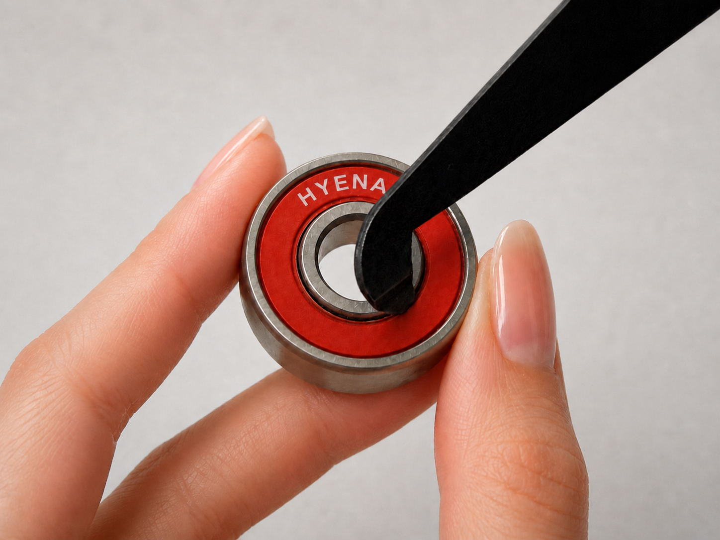 HYENA Pop Key opening a red bearing shield