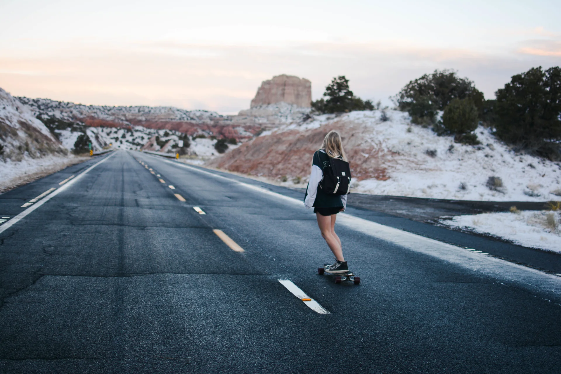 HYENA rider carving across rough ground with a skateboard